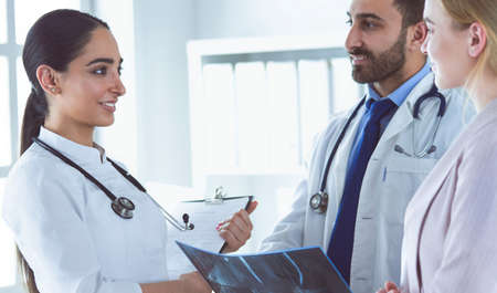A female doctor is showing another doctor a x-ray in her officeの写真素材