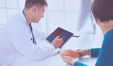 Doctor showing young patient her chest xray in his office at the hospitalの写真素材