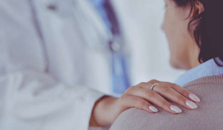 Female doctor giving a consultation to a patient and explaining medical informations and diagnosisの写真素材