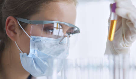 Researcher, doctor, scientist or laboratory assistant working with plastic medical tubes in modern lab or hospitalの写真素材