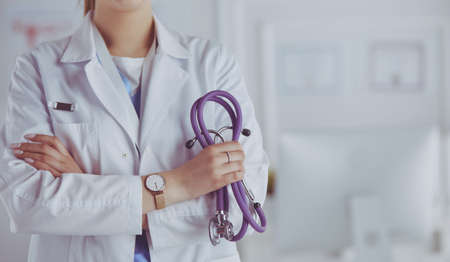 Smiling medical doctor woman with stethoscope in hospitalの写真素材