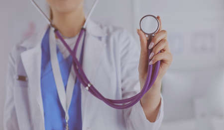 Smiling medical doctor woman with stethoscope in hospitalの写真素材
