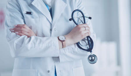Smiling medical doctor woman with stethoscope in hospitalの写真素材