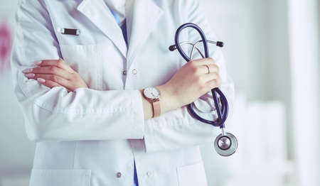 Smiling medical doctor woman with stethoscope in hospitalの写真素材