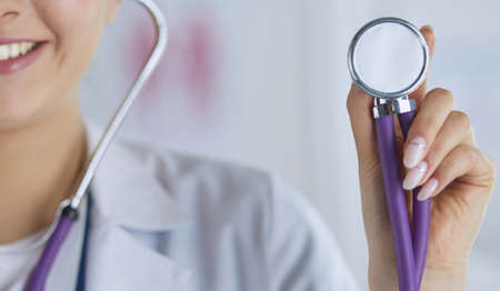 Smiling medical doctor woman with stethoscope in hospitalの写真素材