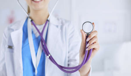 Smiling medical doctor woman with stethoscope in hospital.の写真素材