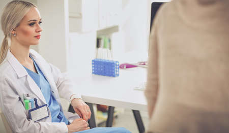 Doctor and patient discussing something while sitting at the table . Medicine and health care concept. Doctor and patientの写真素材