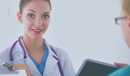 Woman doctor standing with stethoscope at hospitalの写真素材