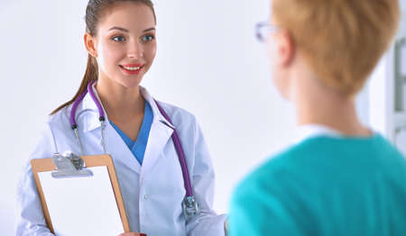 Woman doctor standing with folder at hospitalの写真素材