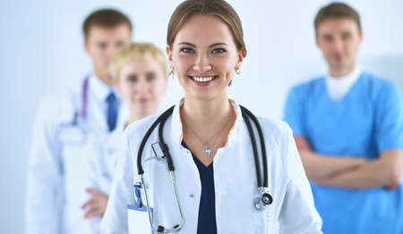 Attractive female doctor in front of medical groupの写真素材