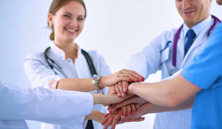 Doctors and nurses in a medical team stacking handsの写真素材