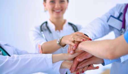Doctors and nurses in a medical team stacking handsの写真素材
