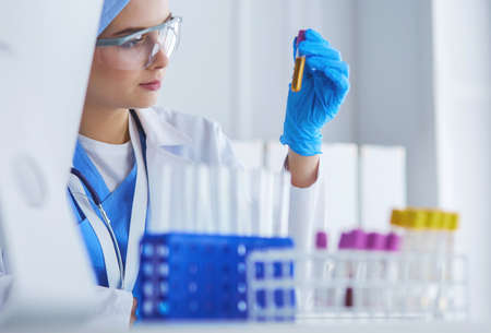 laboratory assistant woman analyzing a blood sampleの写真素材