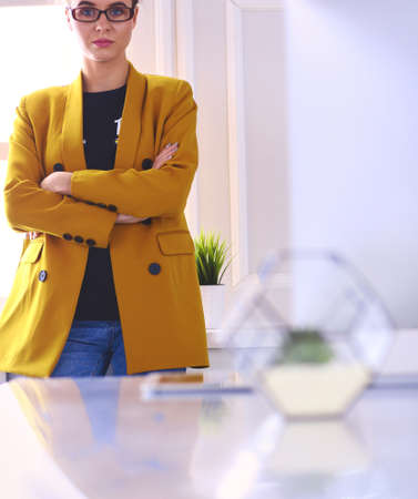 Portrait of a beautiful business woman standing near her workplaceの写真素材