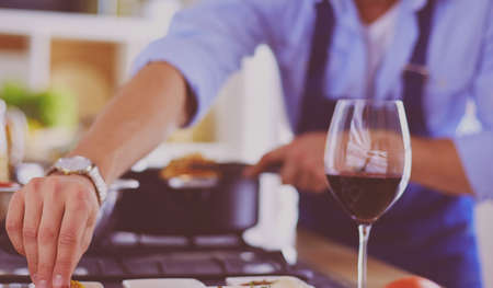 Man preparing delicious and healthy food in the home kitchenの写真素材