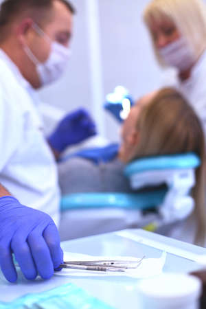 Detail of hand holding dental tools in dental clinic. Dentist Conceptの写真素材