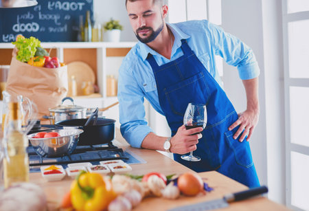 Man preparing delicious and healthy food in the home kitchenの写真素材