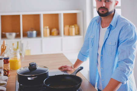 Man preparing delicious and healthy food in the home kitchenの写真素材