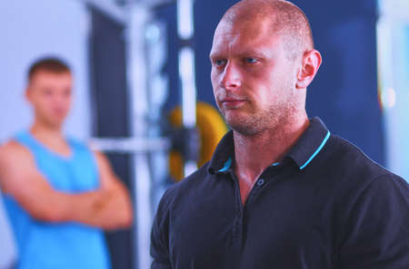 Bodybuilder with barbell in gymの写真素材