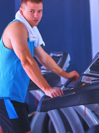 Man at the gym exercising on cross trainersの写真素材