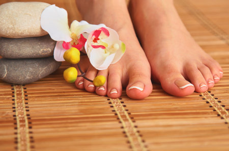 Care for beautiful woman legs with flowerの写真素材