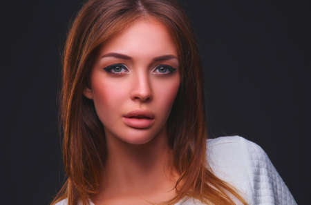 Portrait of a beautiful woman , isolated on black backgroundの写真素材