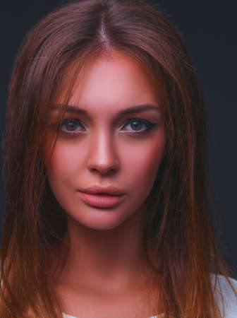 Portrait of a beautiful woman , isolated on black backgroundの写真素材