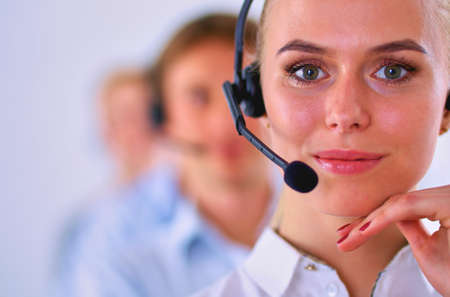 Attractive positive young businesspeople and colleagues in a call center officeの写真素材