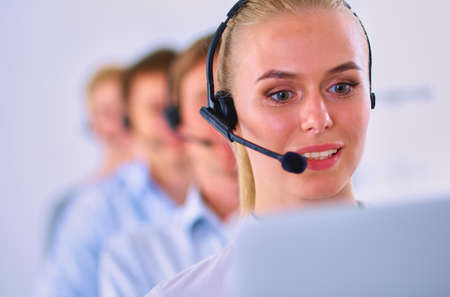 Attractive positive young businesspeople and colleagues in a call center officeの写真素材
