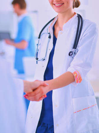Young medical people handshaking at officeの写真素材