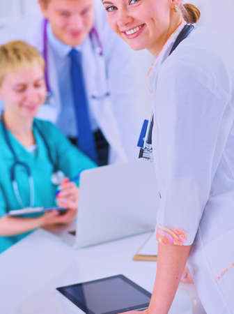 Attractive female doctor in front of medical groupの写真素材