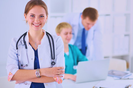 Woman doctor standing with stethoscope at hospitalの写真素材