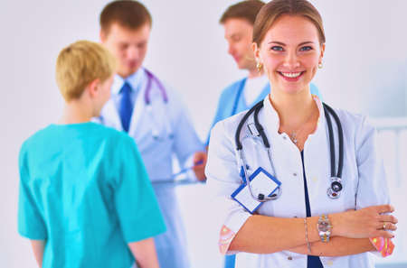 Woman doctor standing with stethoscope at hospitalの写真素材