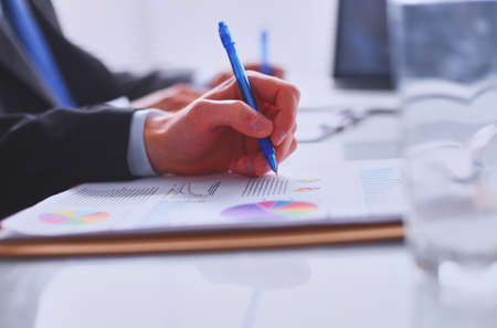 Businesspeople sitting on the desk on officeの写真素材