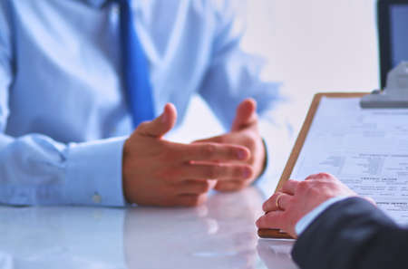 Business people sitting and discussing at business meeting, in officeの写真素材