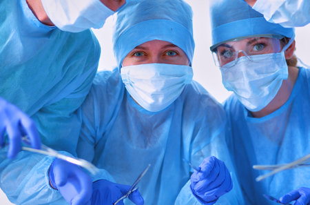 Below view of surgeons holding medical instruments in handsの写真素材