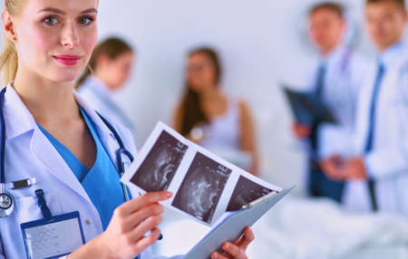 Surgeon and doctor analyzing x-ray together in medical officeの写真素材