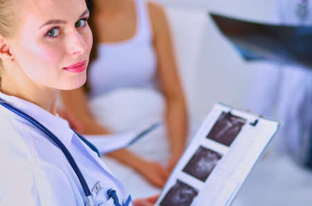 Surgeon and doctor analyzing x-ray together in medical officeの写真素材