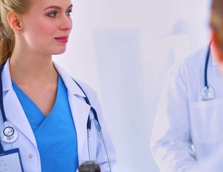 Woman doctor standing with folder at hospitalの写真素材