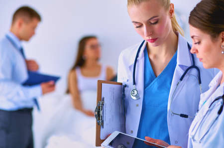 Young woman doctor holding a tablet pcの写真素材