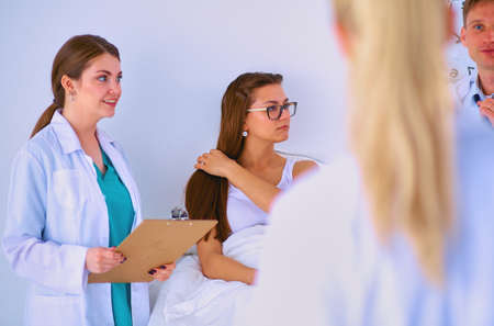 Woman doctor standing with folder at hospitalの写真素材