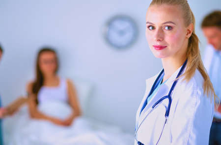 Woman doctor standing with folder at hospitalの写真素材