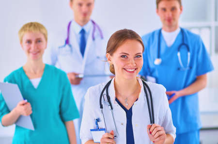 Attractive female doctor in front of medical groupの写真素材