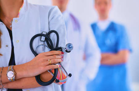 Attractive female doctor in front of medical groupの写真素材