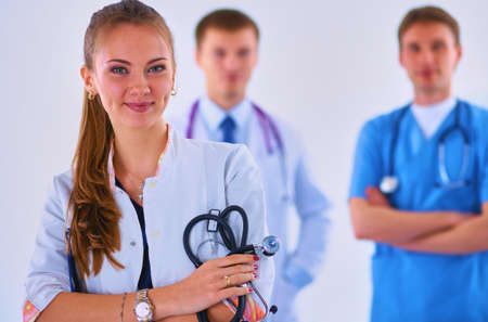 Attractive female doctor in front of medical groupの写真素材