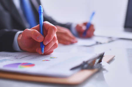 Businesspeople sitting on the desk on officeの写真素材