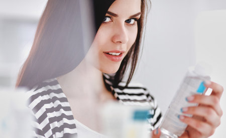Portrait of Beautiful young woman standing in shopの写真素材