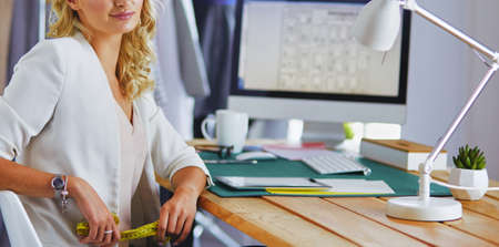 Fashion designer woman working on her designs in the studio.の写真素材