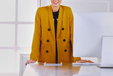 Portrait of a beautiful business woman standing near her workplaceの写真素材