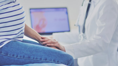 Young woman doctor standing at hospital with medical stethoscopeの写真素材
